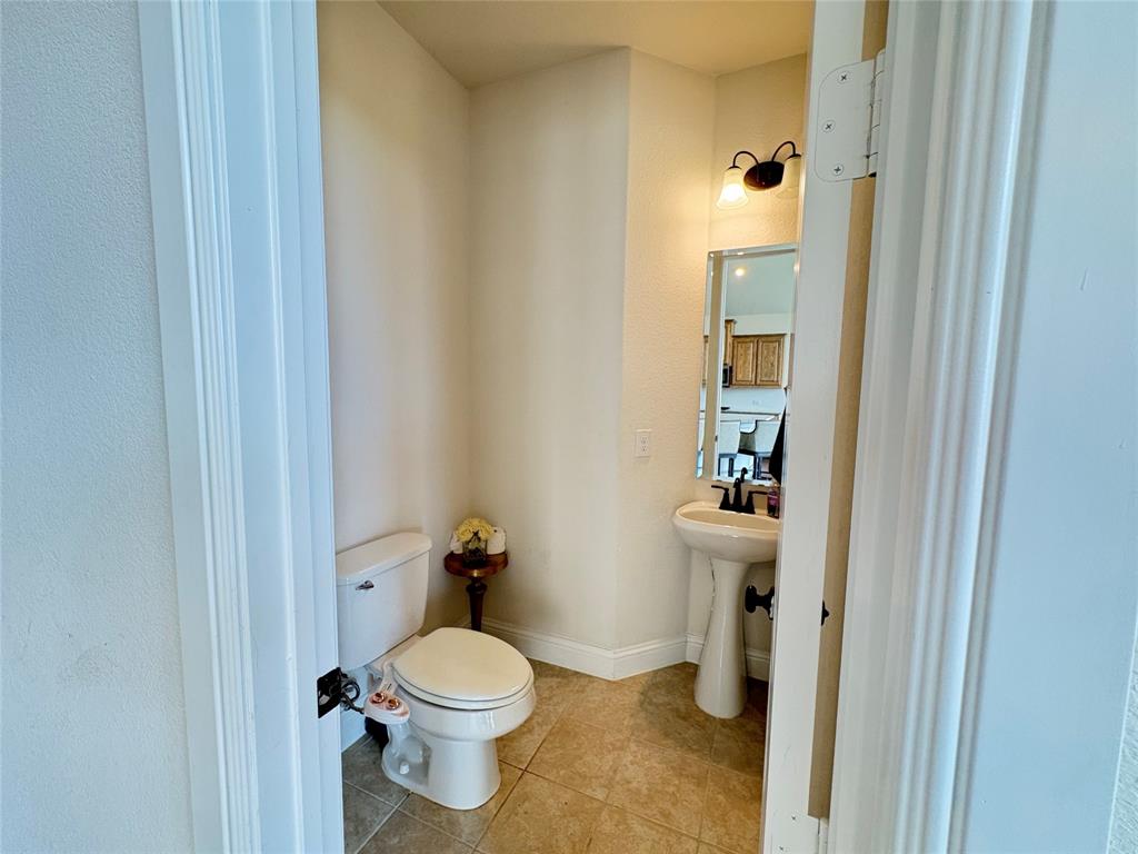 323 Butternut Way Irving, TX 75063 - Photo 15 of 32 a bathroom with a toilet and a sink