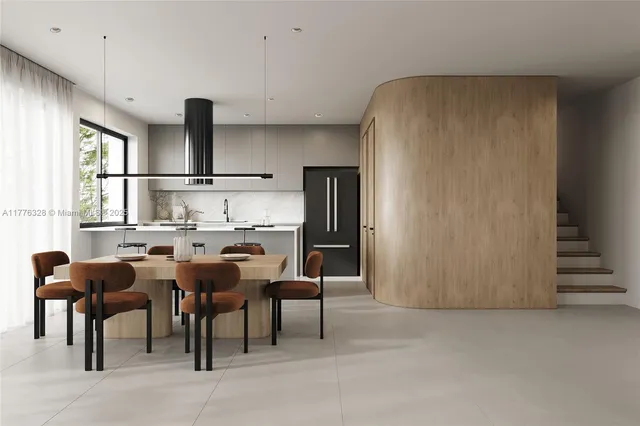 a kitchen with stainless steel appliances refrigerator table and chairs