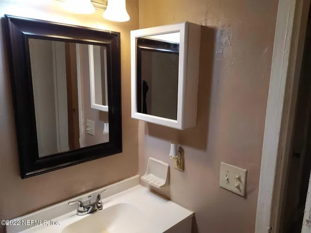 a bathroom with a sink and a mirror
