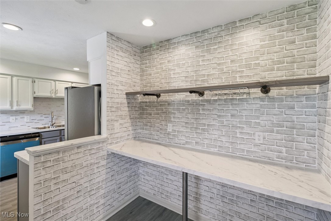 3930 Wood Road Madison, OH 44057 - Photo 24 of 45 Kitchen featuring freestanding refrigerator, white cabinets, decorative backsplash, dishwasher, and recessed lighting
