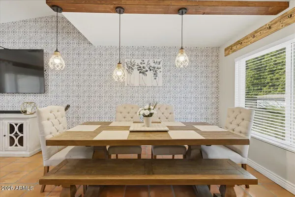 a kitchen with a table chairs and microwave