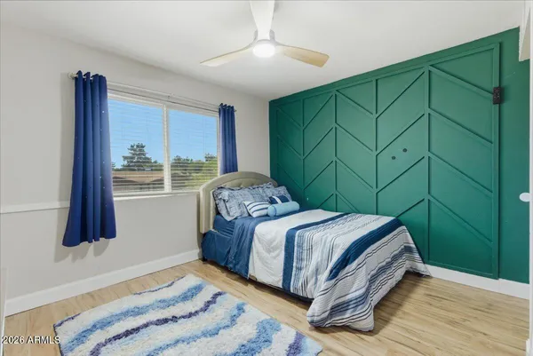 a view of a kitchen with wooden floor and electronic appliances