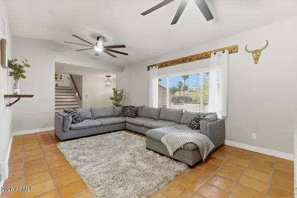 a bedroom with two beds and a chandelier