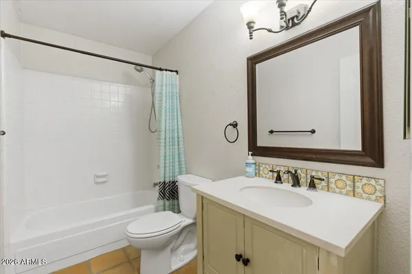 a living room with furniture and a ceiling fan