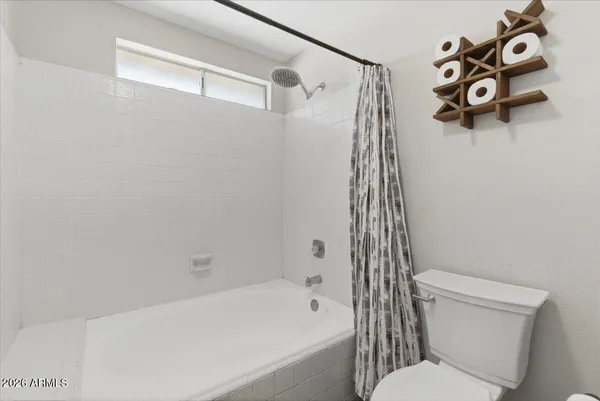 a spacious bedroom with a bed and a window