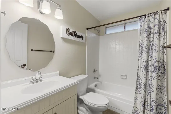 a bathroom with double vanity sinks and a mirror