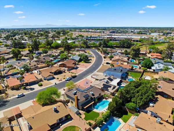 a view of yard with swimming pool and green space