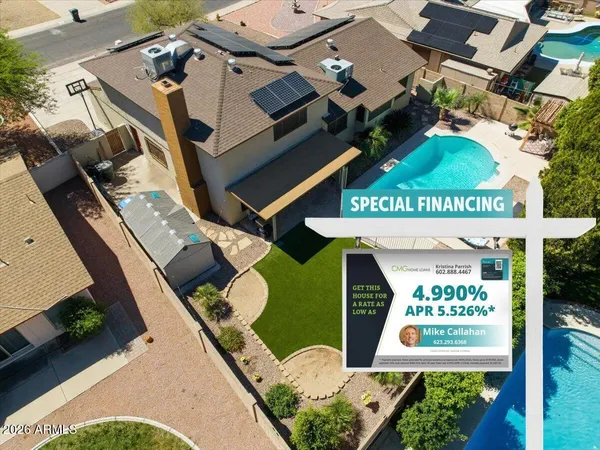 an aerial view of a city with lots of residential buildings and parking space