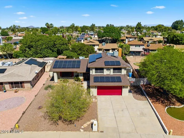 a view of a house with a backyard patio and entertaining space