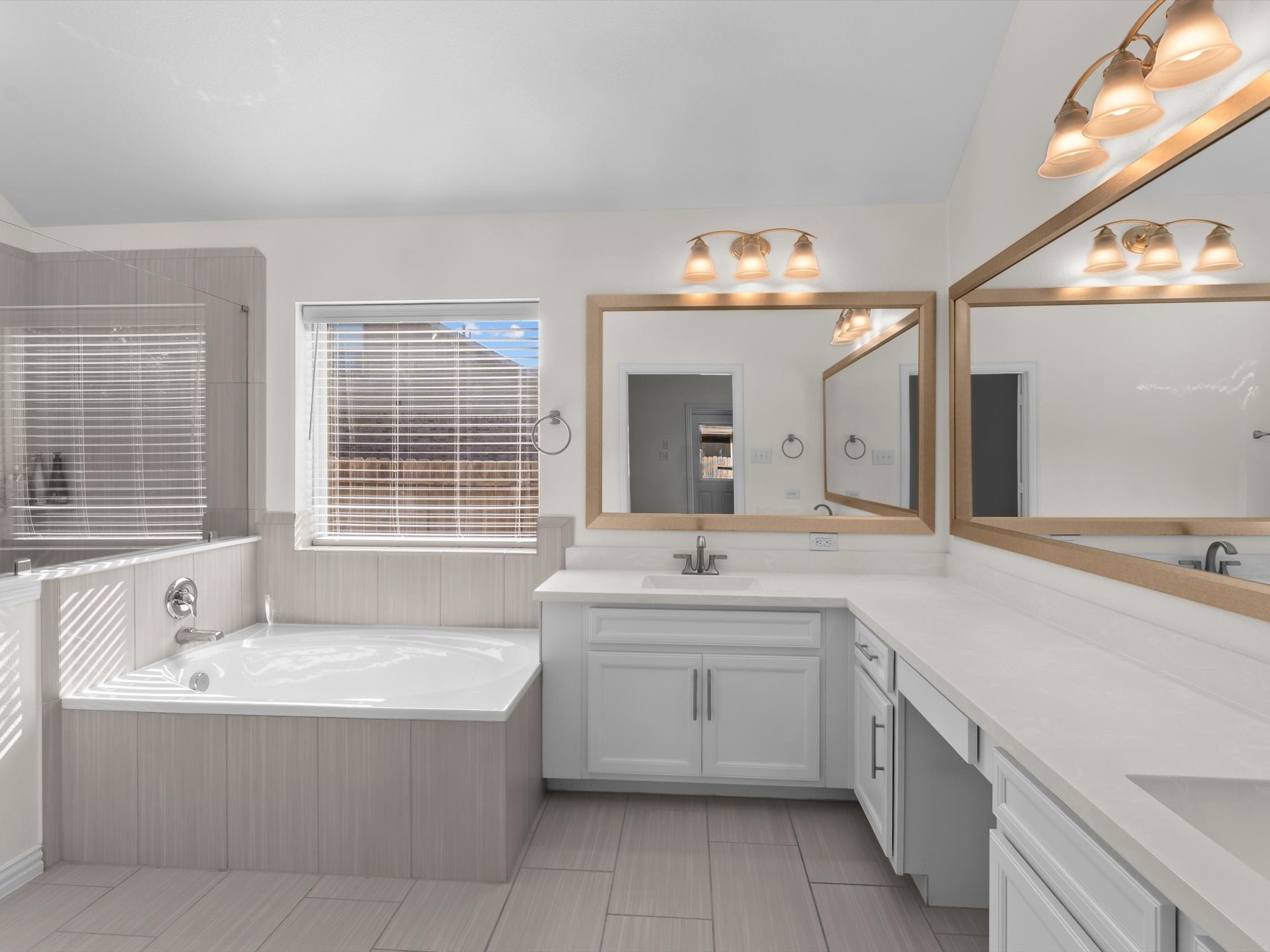 4746 Misty Ranch Drive Spring, TX 77386 - Photo 29 of 49 Primary bathroom retreat with double sinks, a dedicated vanity area, abundant cabinet storage, and a separate soaking tub and walk-in shower.