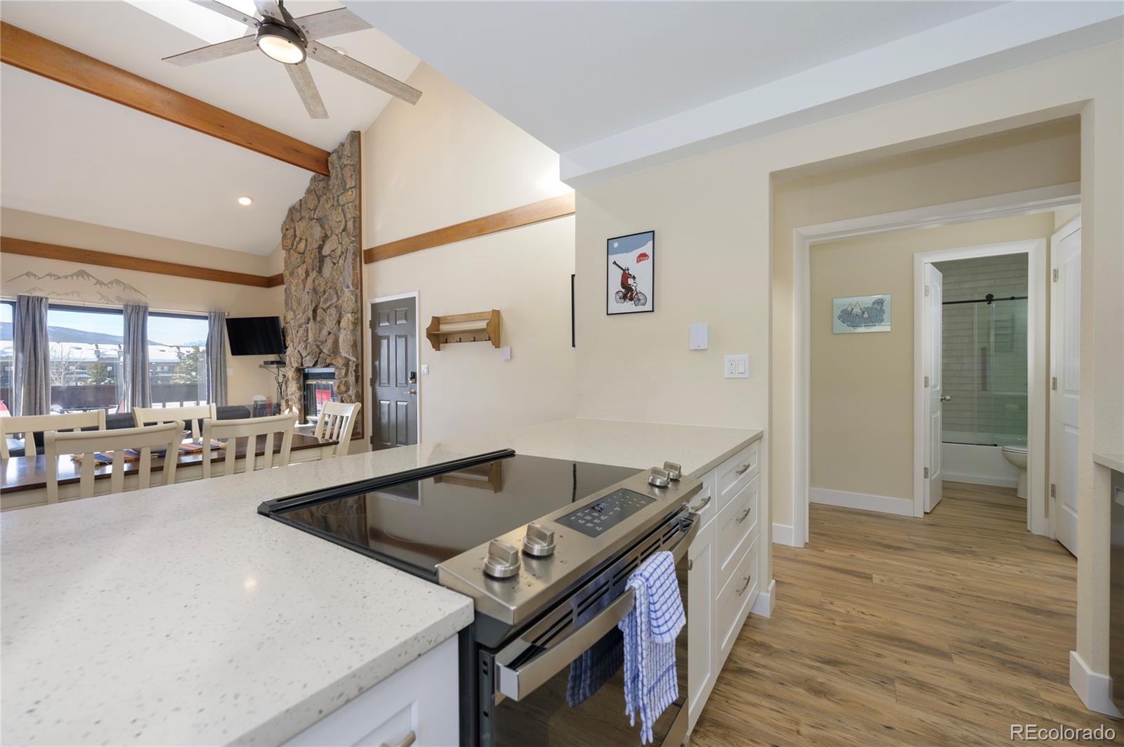 83 County Road, Unit F7 Fraser, CO 80442 - Photo 8 of 20 a kitchen that has a sink and a stove with wooden floor