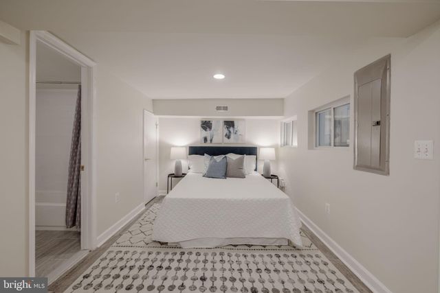 a large bedroom with a bed and a lamp