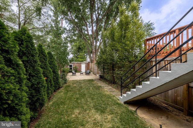 a view of a patio with table and chairs and potted plants