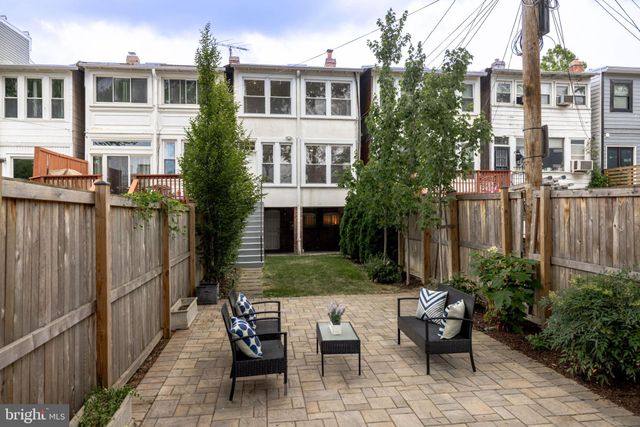 a view of a patio with couches and potted plants