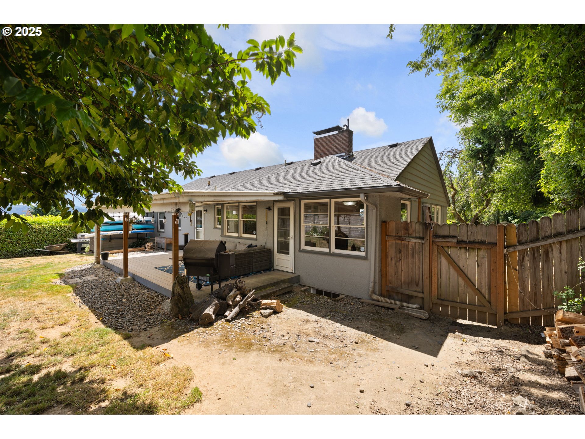 632 Northeast Everett Street Camas, WA 98607 - Photo 42 of 47 a front view of house with yard outdoor seating and covered with trees in the background
