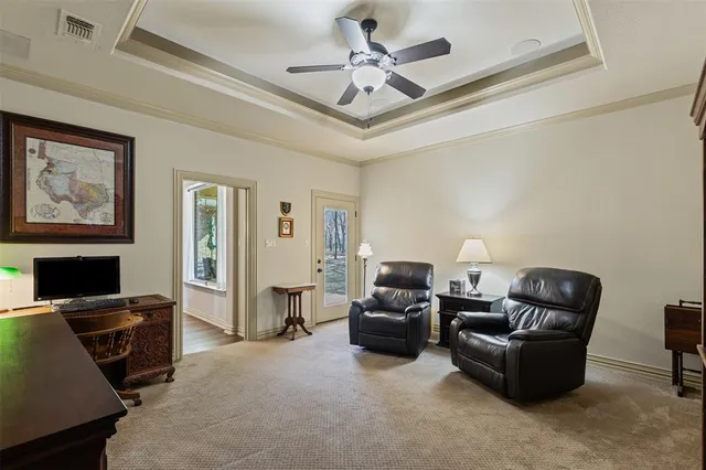 a living room with furniture a ceiling fan and a window