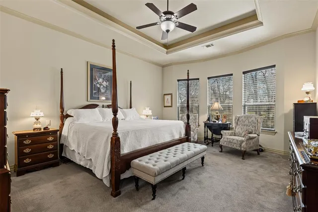 a bedroom with a bed mirror and couch