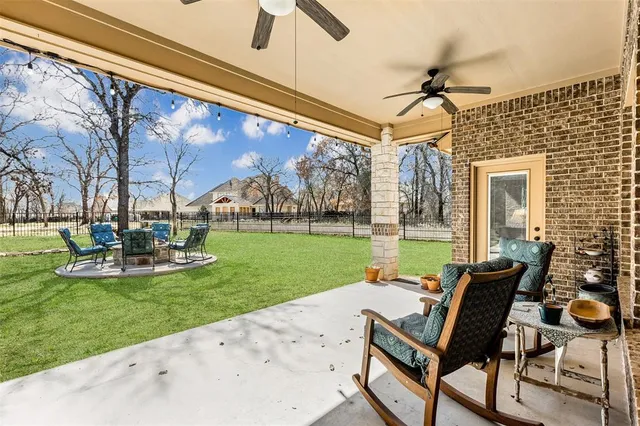 a view of a porch with furniture and garden