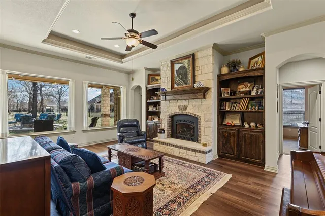 a living room with furniture a bookshelf and a fireplace