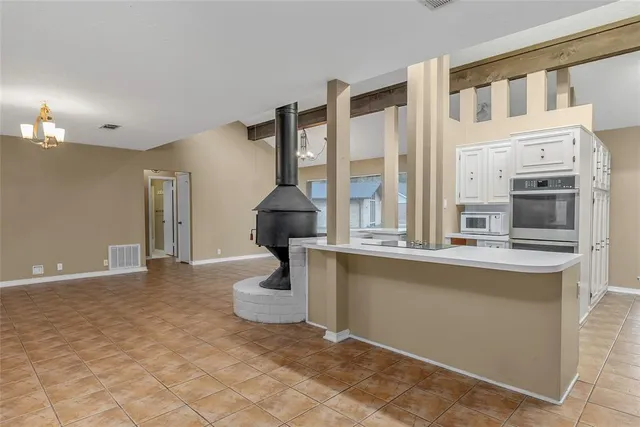 a view of a kitchen with furniture and a fireplace
