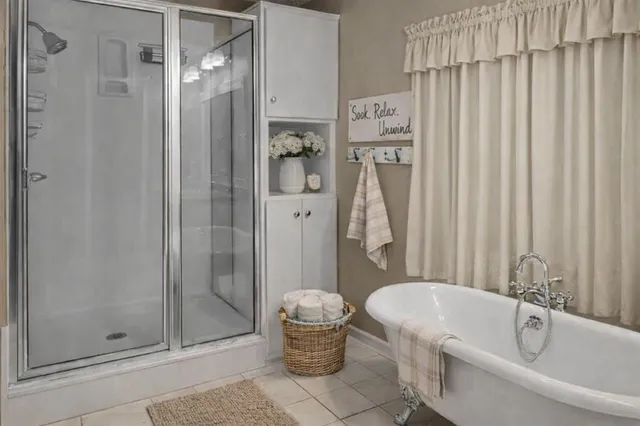 a bathroom with a tub and shower