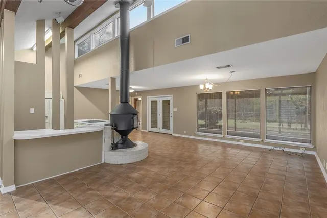 a view of a room with gym equipment and large windows