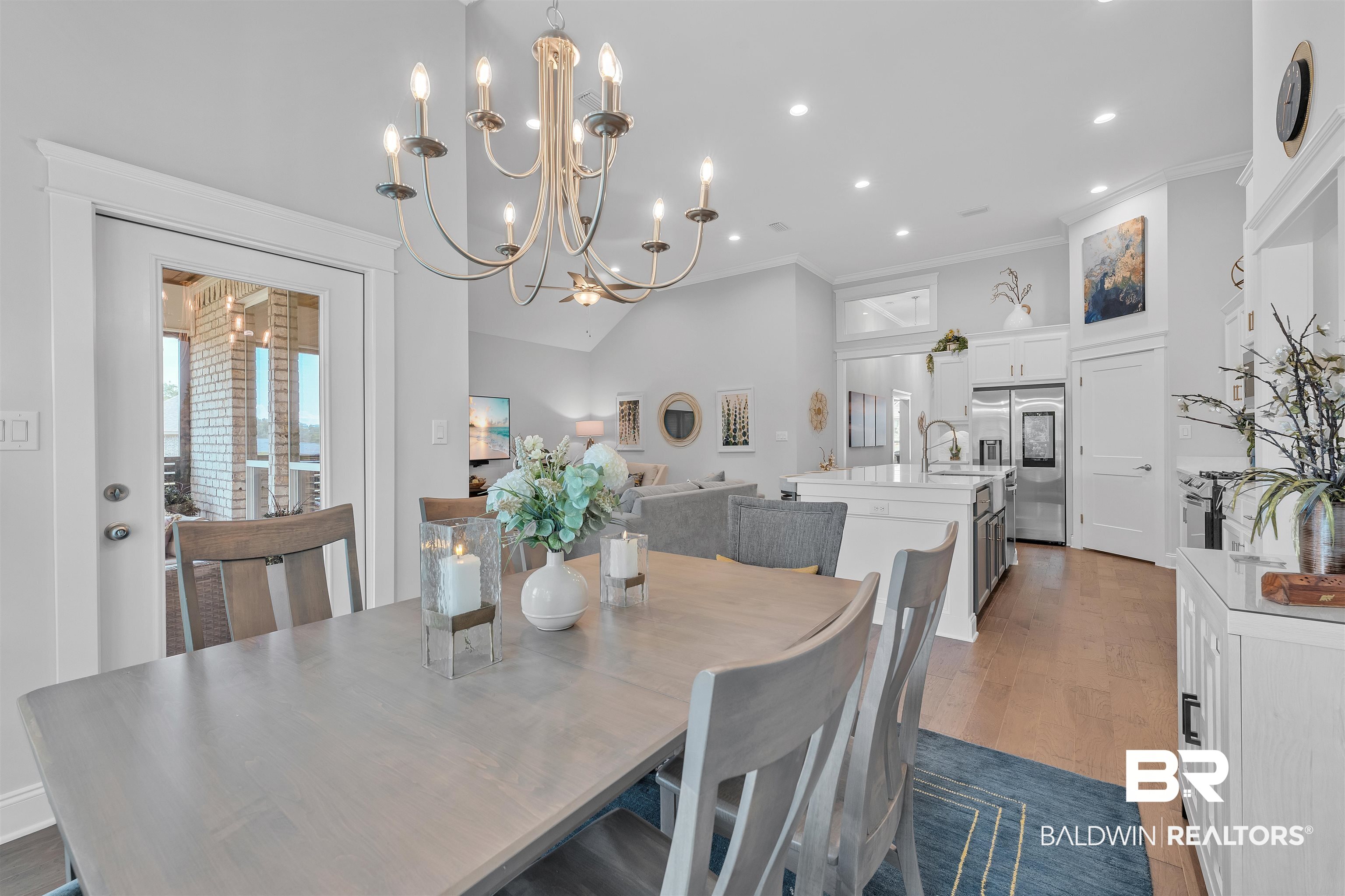 31630 Canopy Loop Daphne, AL 36527 - Photo 9 of 30 Dining room featuring ornamental molding, a towering ceiling, wood finished floors, recessed lighting, and a notable chandelier