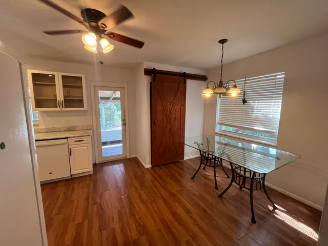 a view of a room with furniture and wooden floor