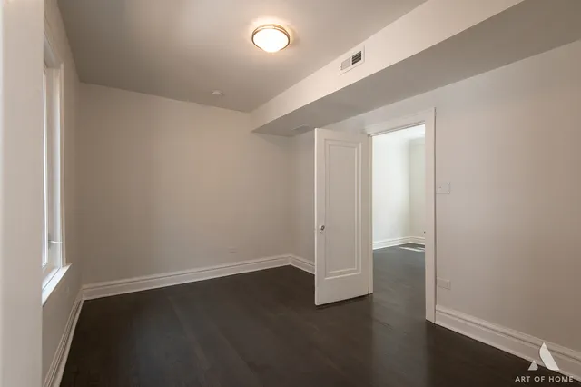 an empty room with wooden floor