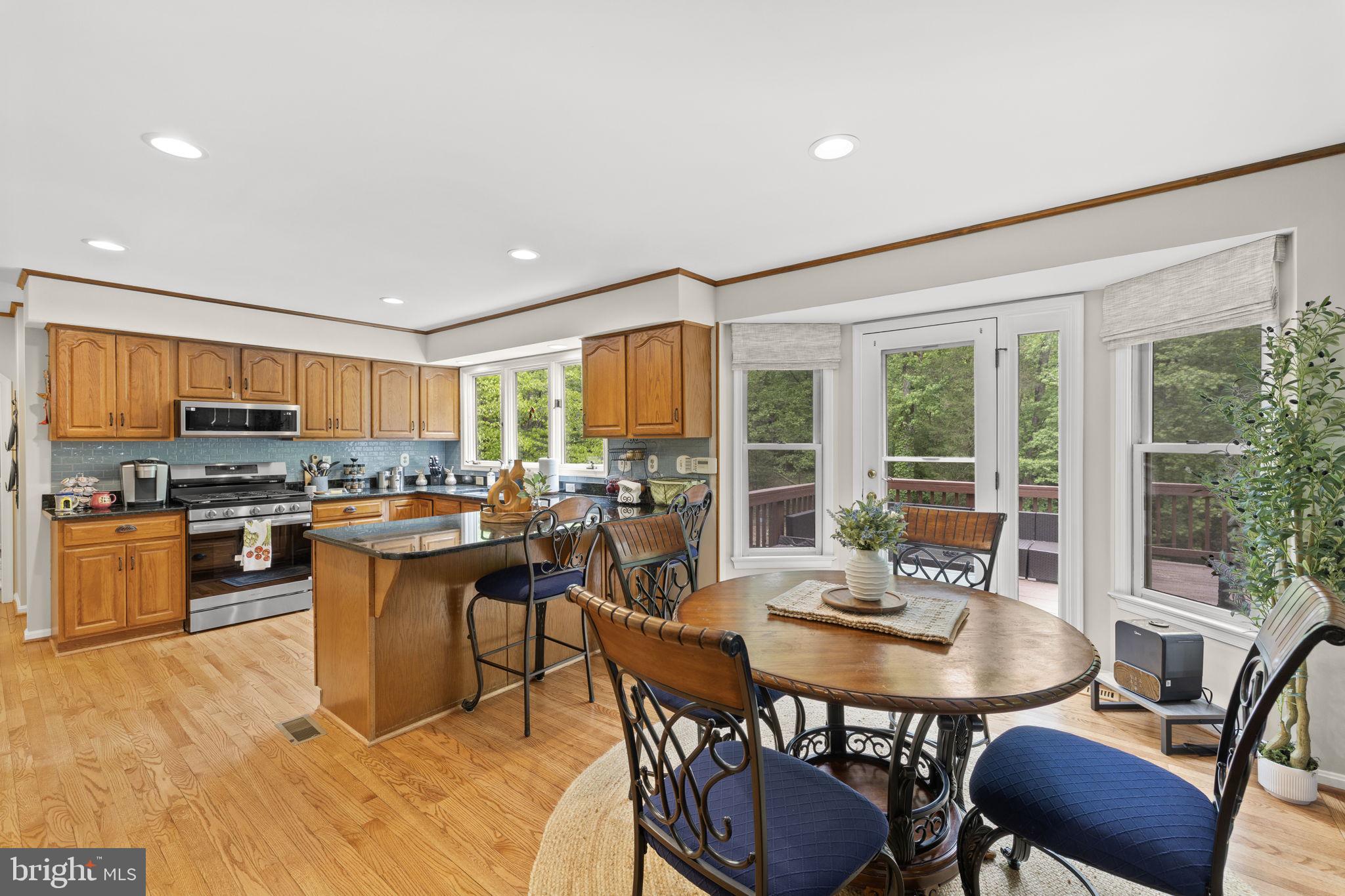 100 Boscobel Road Fredericksburg, VA 22405 - Photo 26 of 67 a dining room with a table chairs and kitchen view