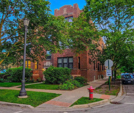 a front view of a house with a yard and tree s