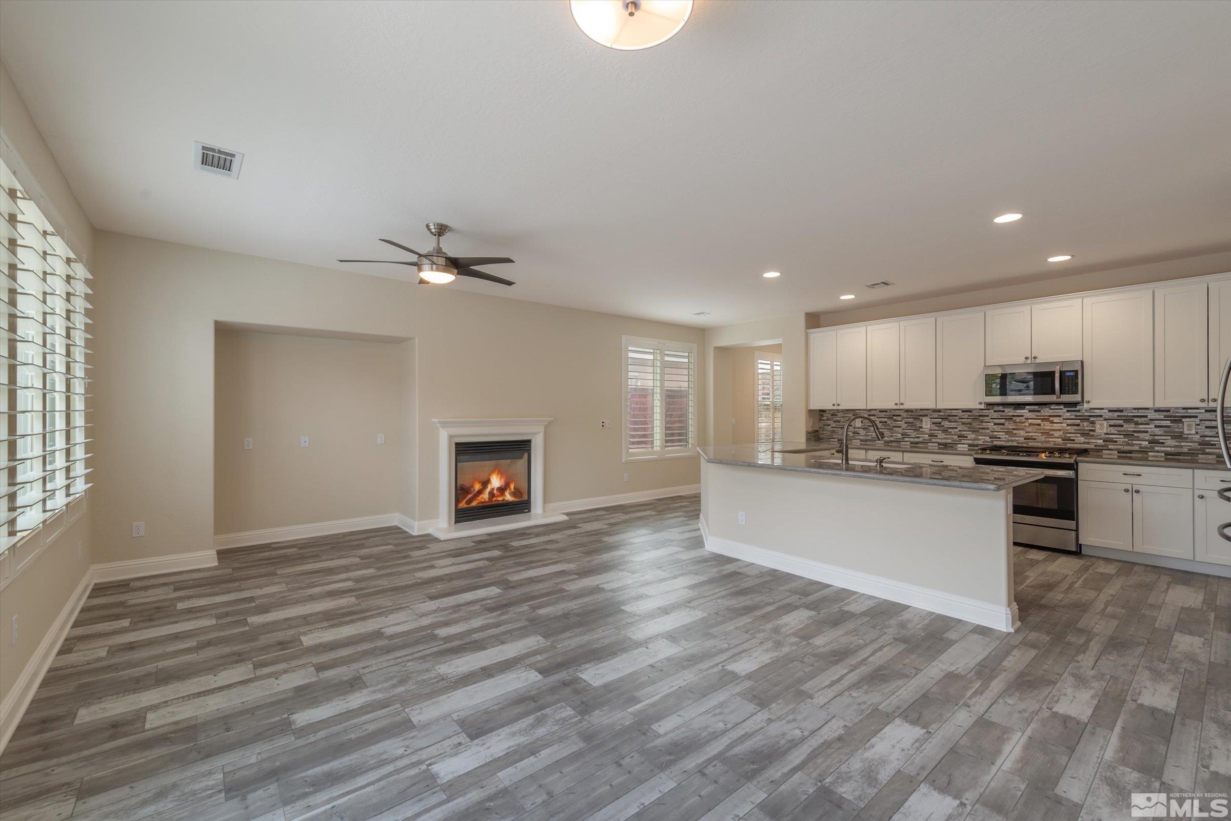 9125 Heritage Ridge Court Reno, NV 89523 - Photo 8 of 40 a view of a kitchen with a sink a fireplace and window
