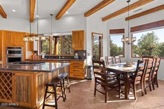 a dining room with furniture a fireplace and a chandelier