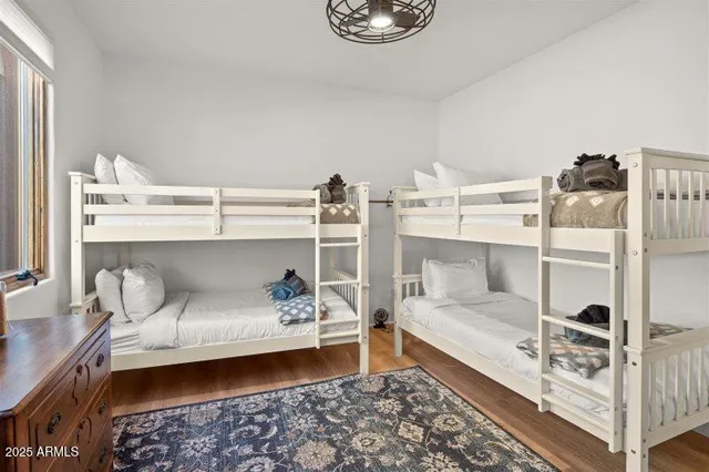 a bathroom with a sink double vanity granite tub shower and a mirror