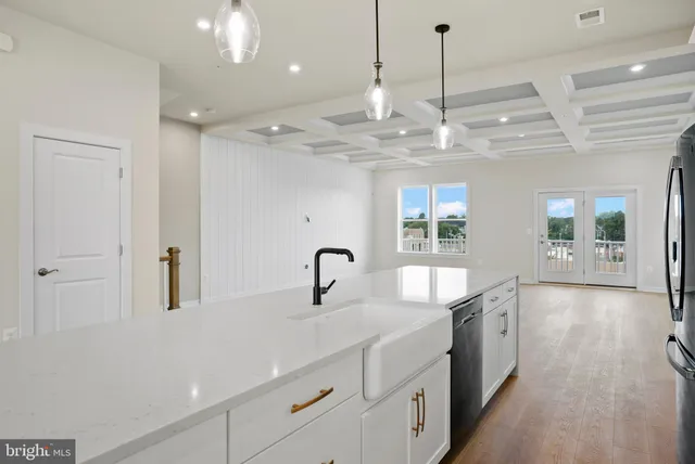 a kitchen with stainless steel appliances granite countertop a sink a oven and a large window