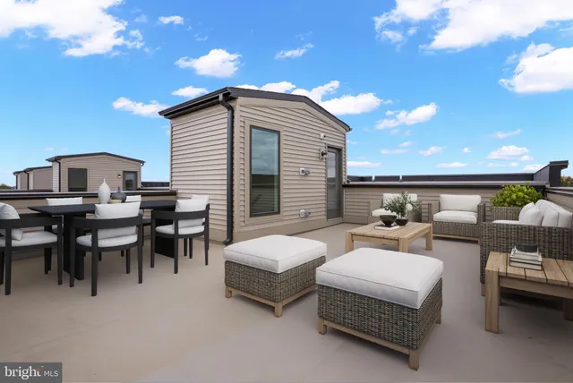 a view of a patio with dining table and chairs with wooden floor