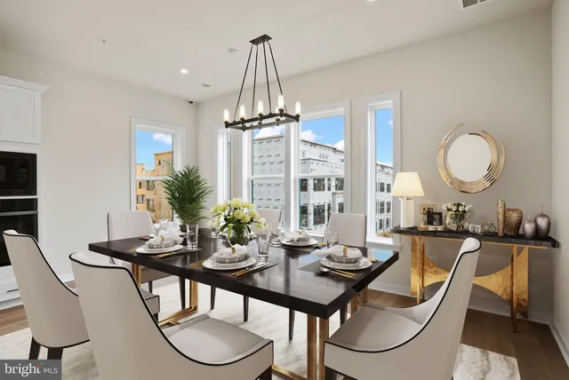 a view of a dining room with furniture window and wooden floor