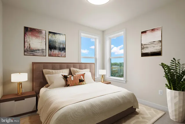 a bedroom with a bed and a potted plant