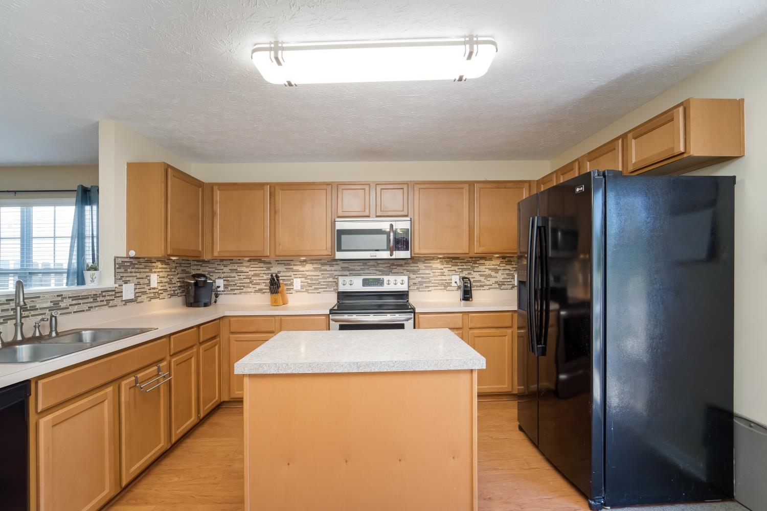 3957 Stephens Ridge Way Antioch, TN 37013 - Photo 7 of 30 a kitchen with stainless steel appliances granite countertop a refrigerator stove microwave and sink
