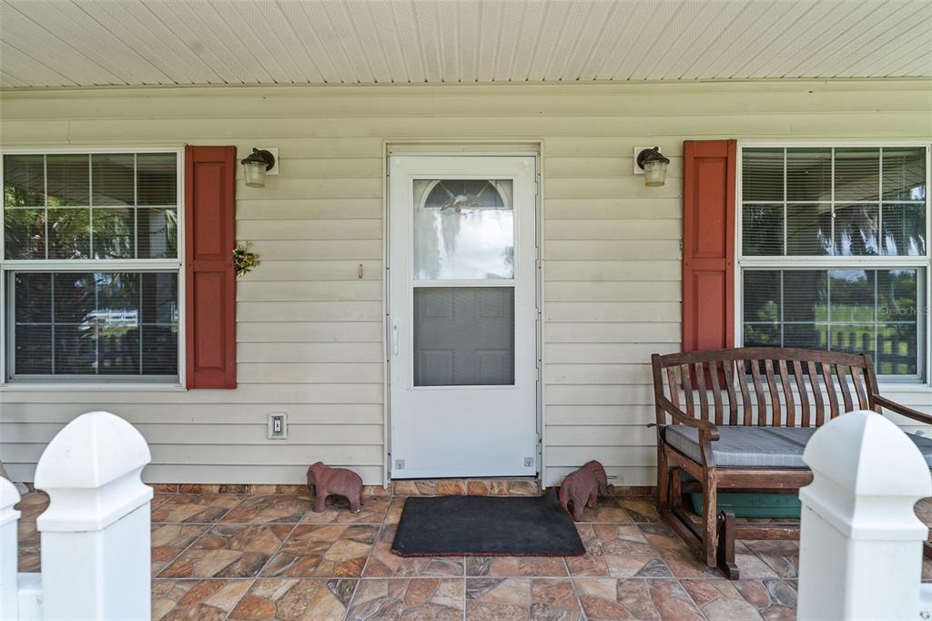 2830 Horton Road Kissimmee, FL 34744 - Photo 3 of 35 a front view of a house with a chairs and table in a patio