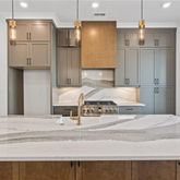 a large kitchen with a refrigerator and countertop