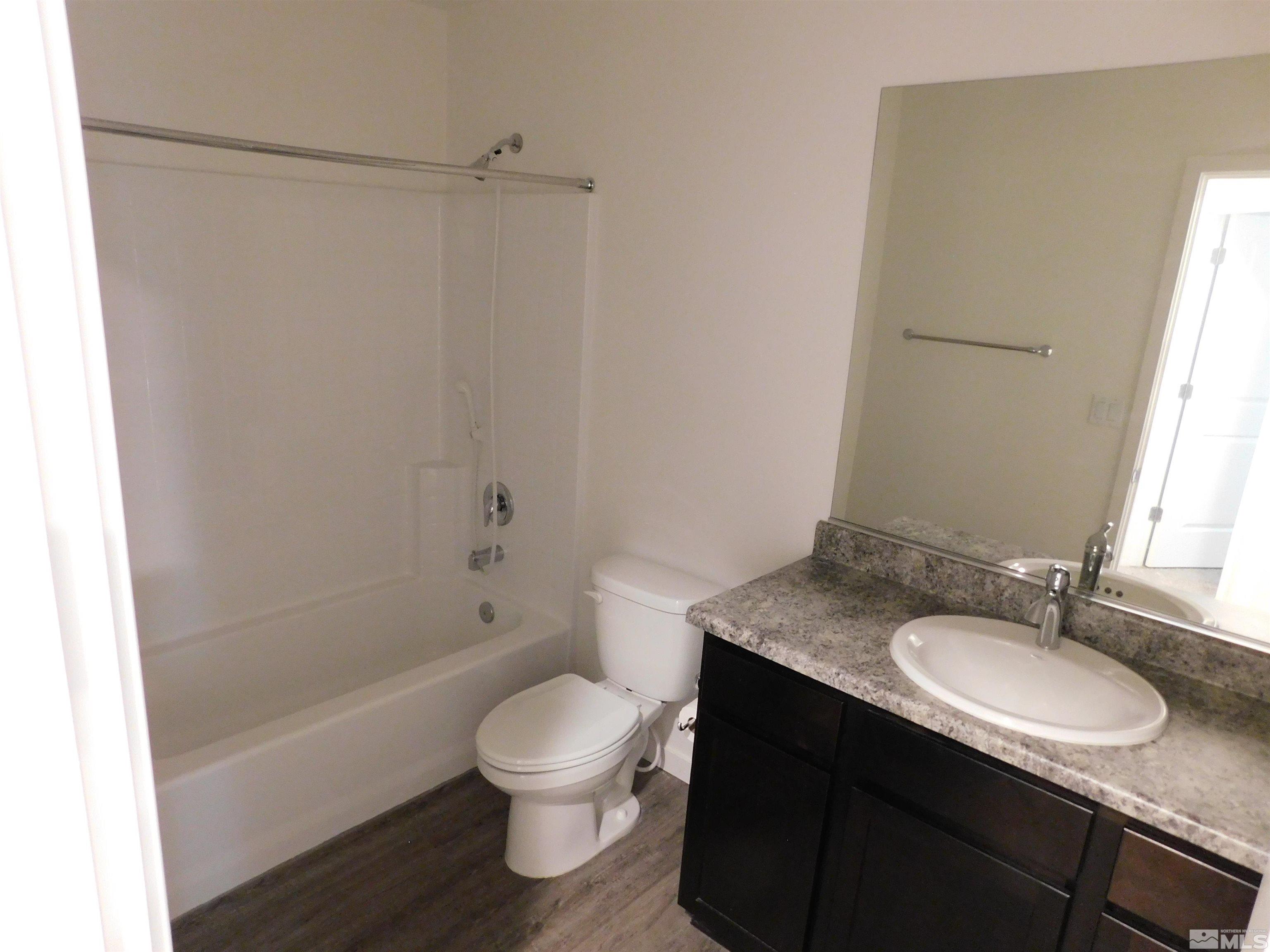 239 Misty Way Dayton, NV 89403 - Photo 11 of 29 a bathroom with a granite countertop sink toilet and shower