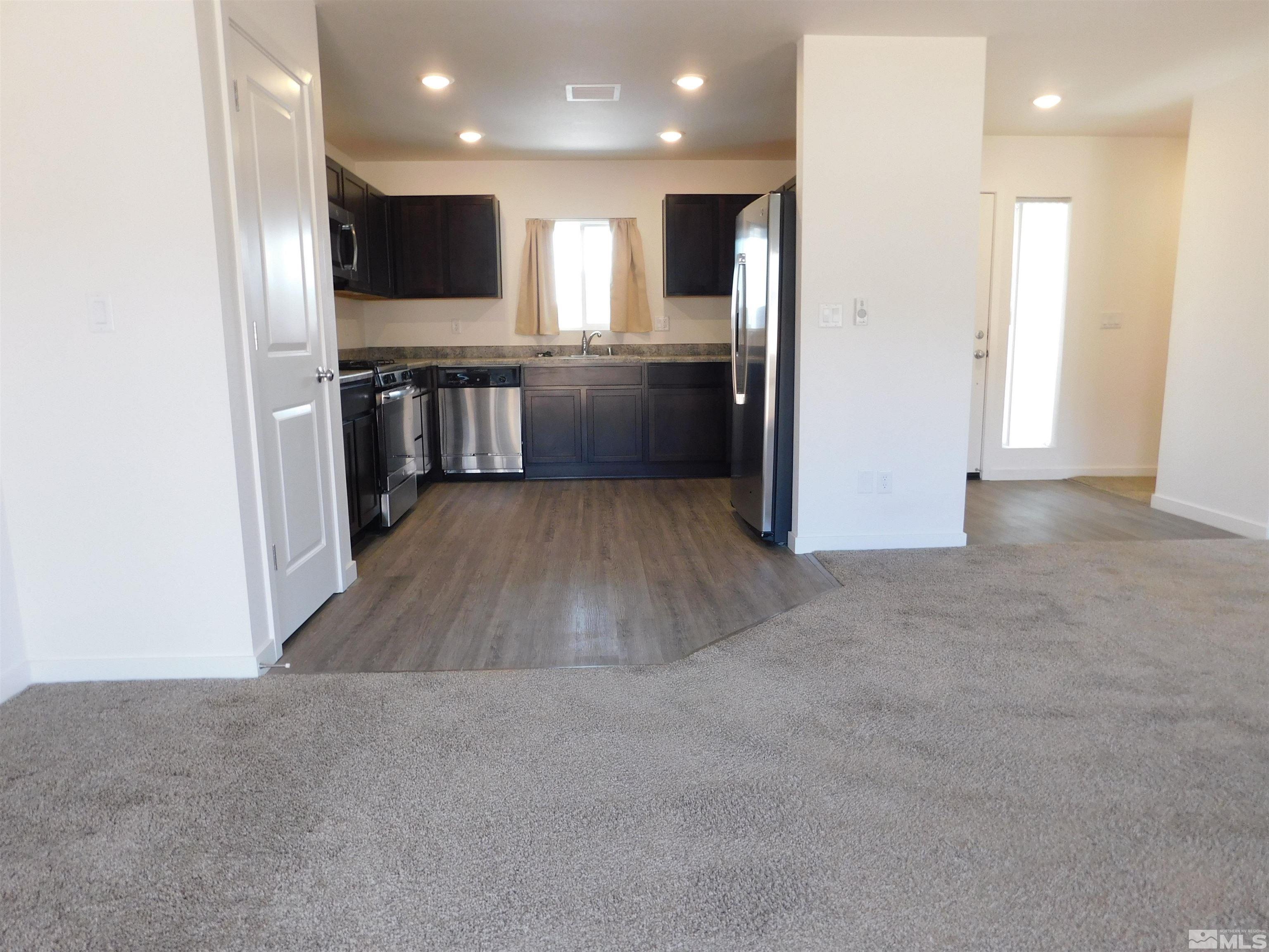 239 Misty Way Dayton, NV 89403 - Photo 2 of 29 a view of kitchen with kitchen island granite countertop stainless steel appliances stove refrigerator and microwave