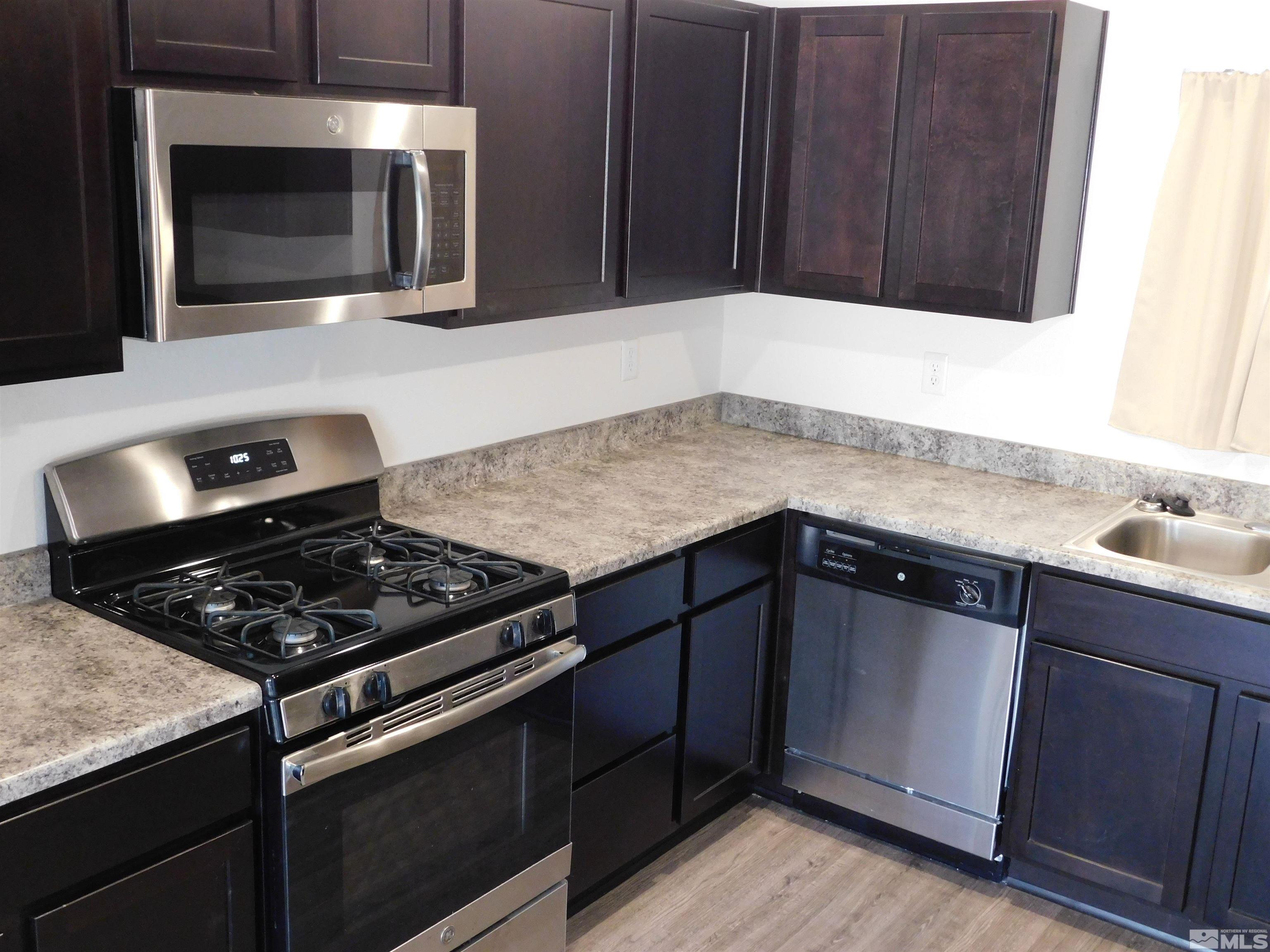 239 Misty Way Dayton, NV 89403 - Photo 21 of 29 a kitchen with granite countertop stainless steel appliances a cabinets and a sink