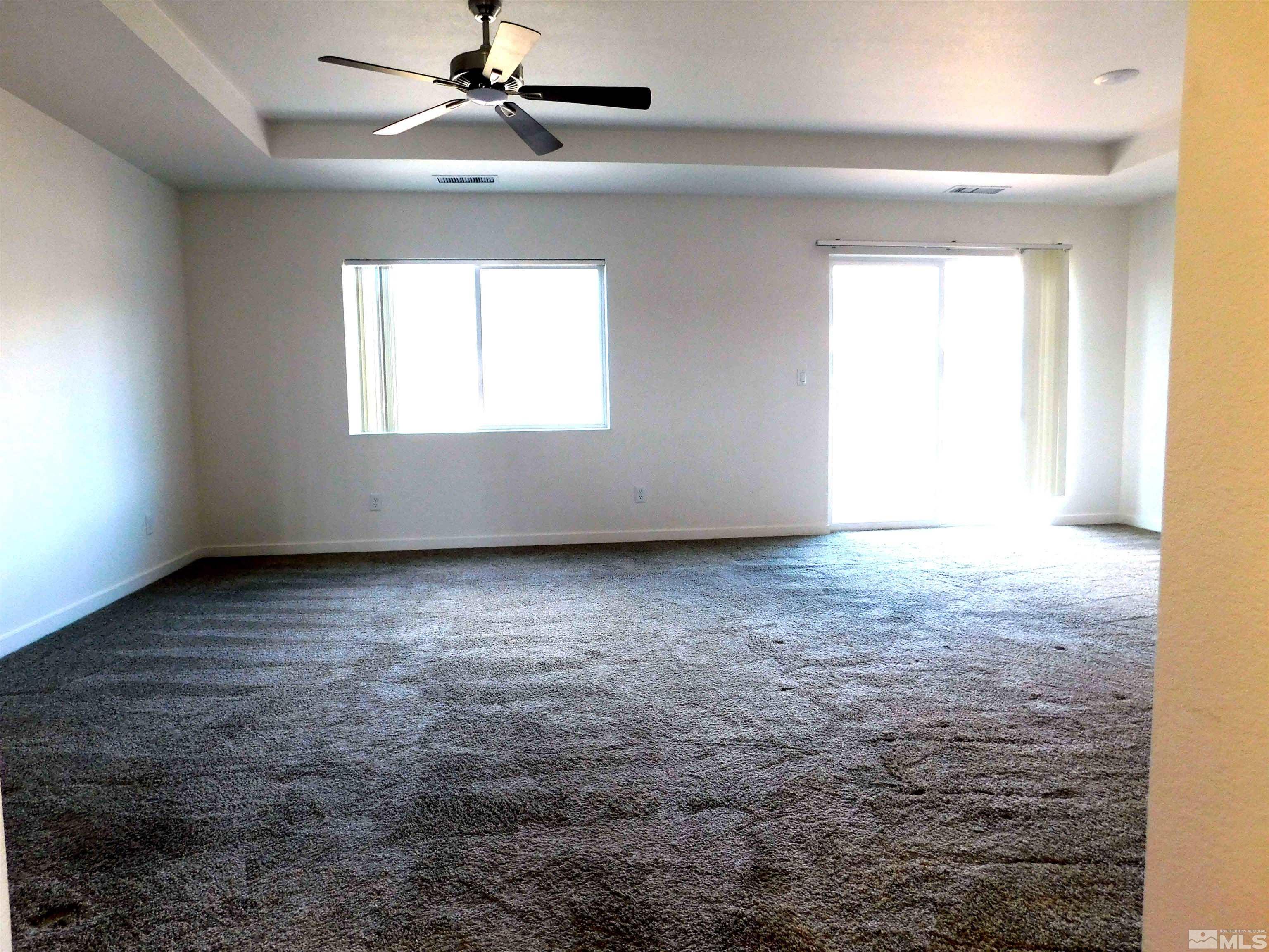 239 Misty Way Dayton, NV 89403 - Photo 23 of 29 an empty room with a window and a ceiling fan