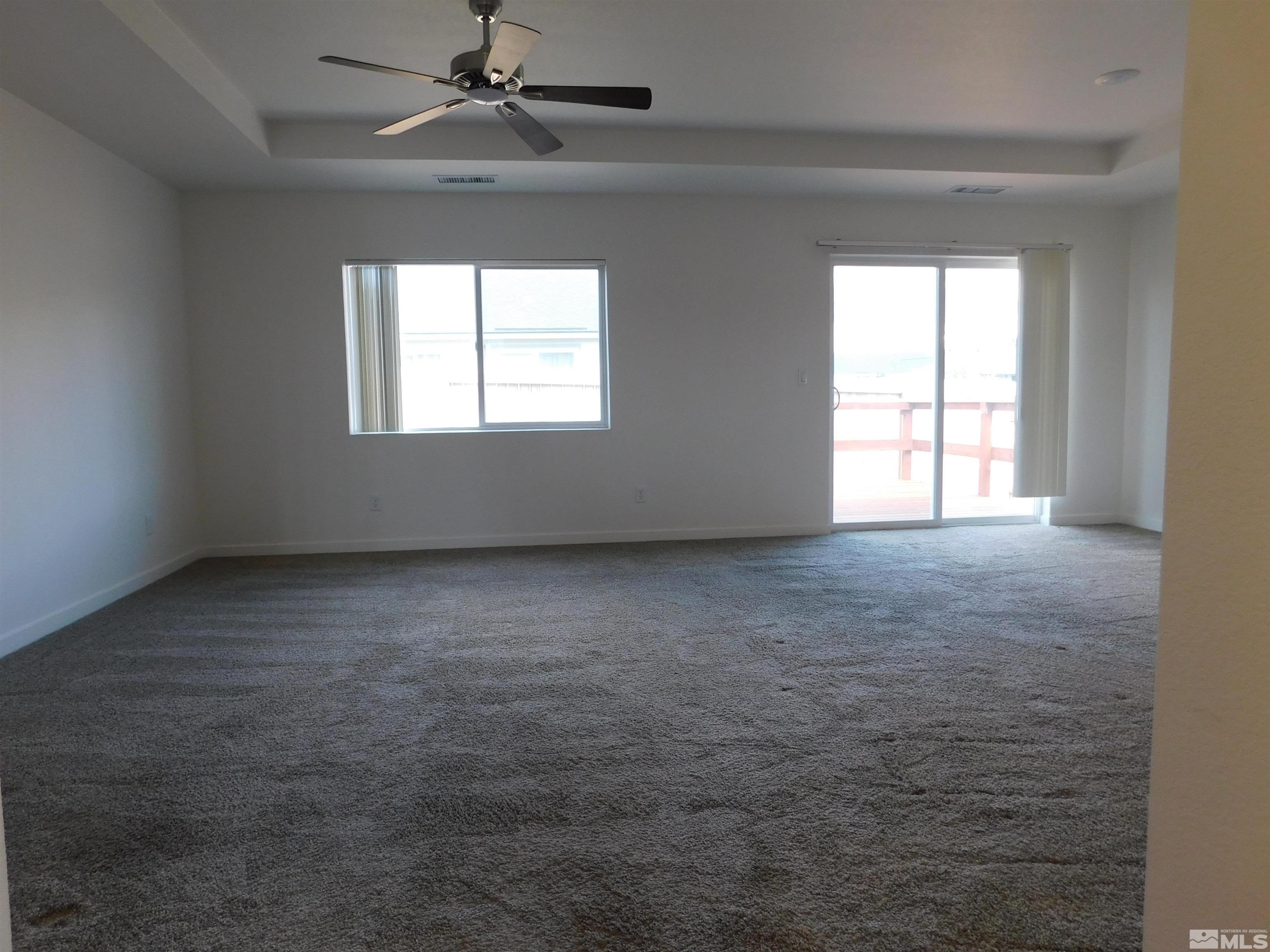 239 Misty Way Dayton, NV 89403 - Photo 27 of 29 an empty room with a window and a ceiling fan