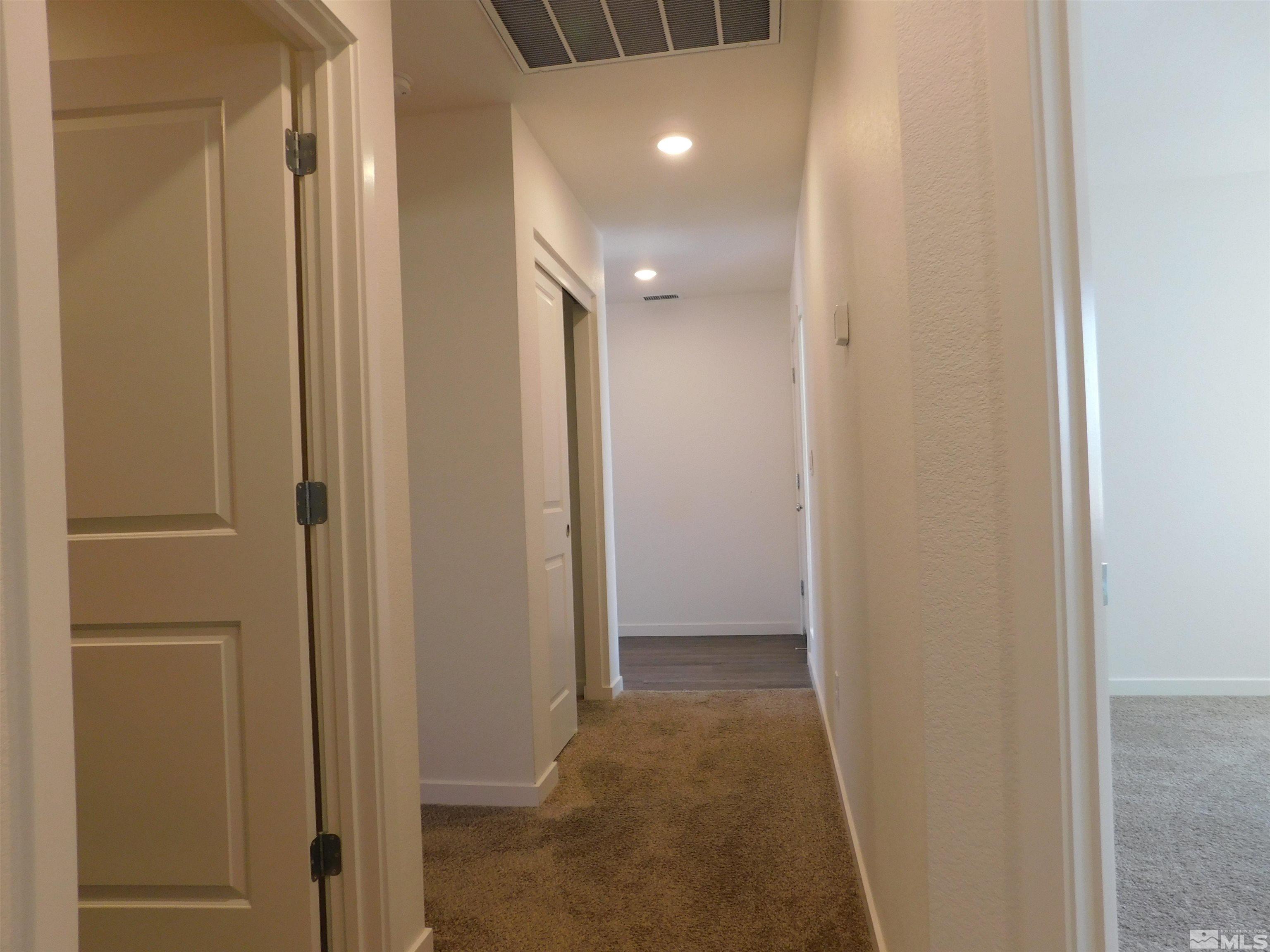239 Misty Way Dayton, NV 89403 - Photo 29 of 29 a view of a hallway with a bathroom