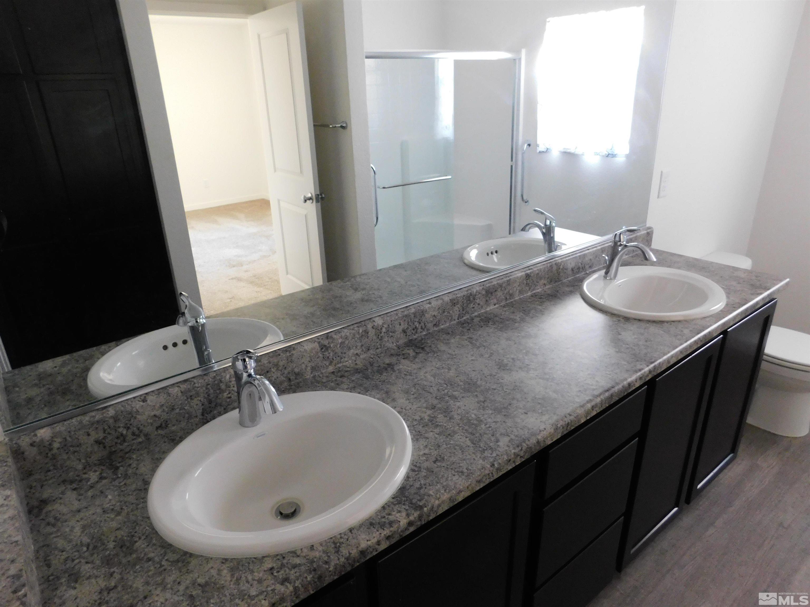239 Misty Way Dayton, NV 89403 - Photo 7 of 29 a bathroom with a double vanity sink and a mirror