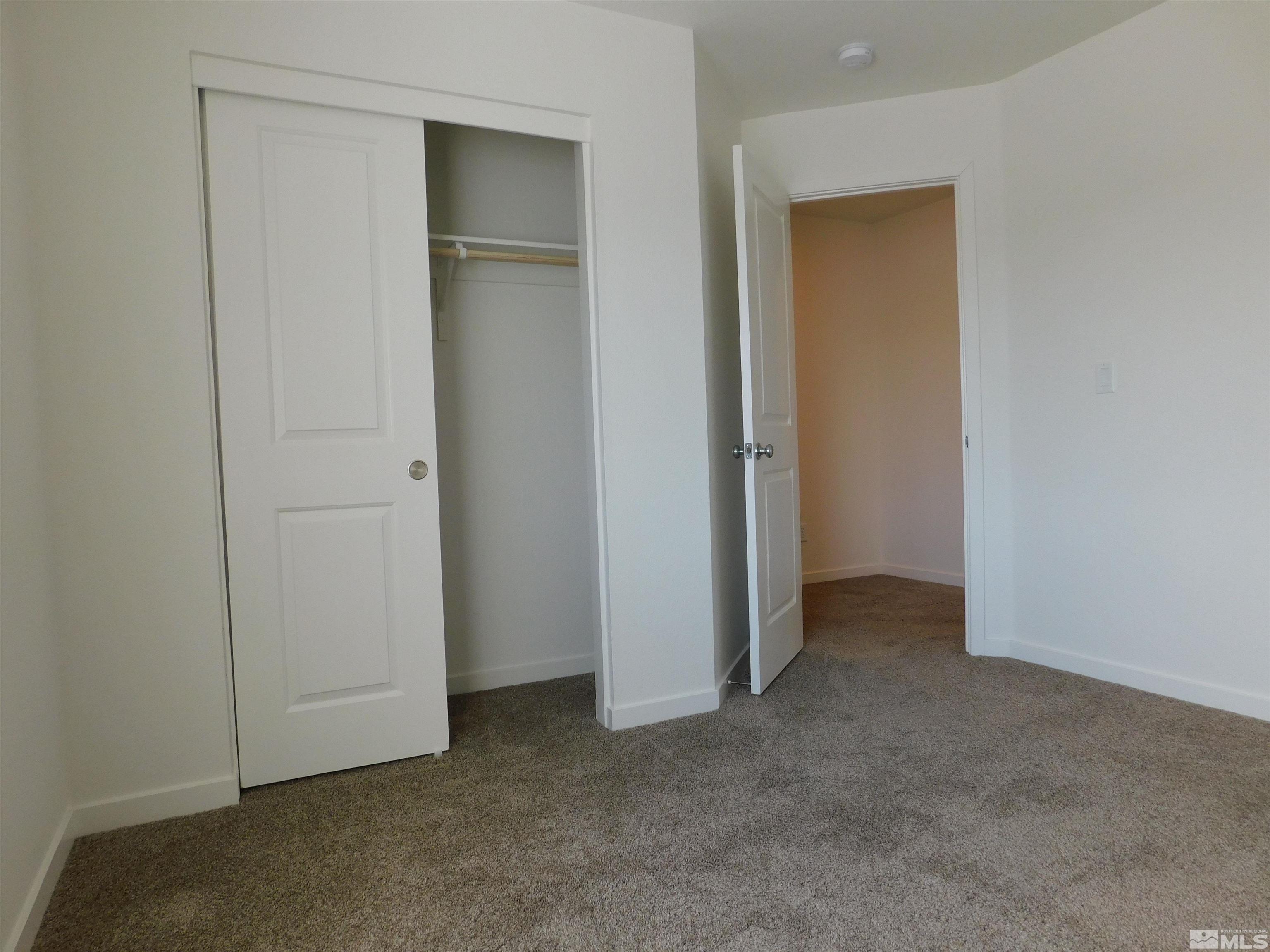 239 Misty Way Dayton, NV 89403 - Photo 9 of 29 an empty room that has a grey walls