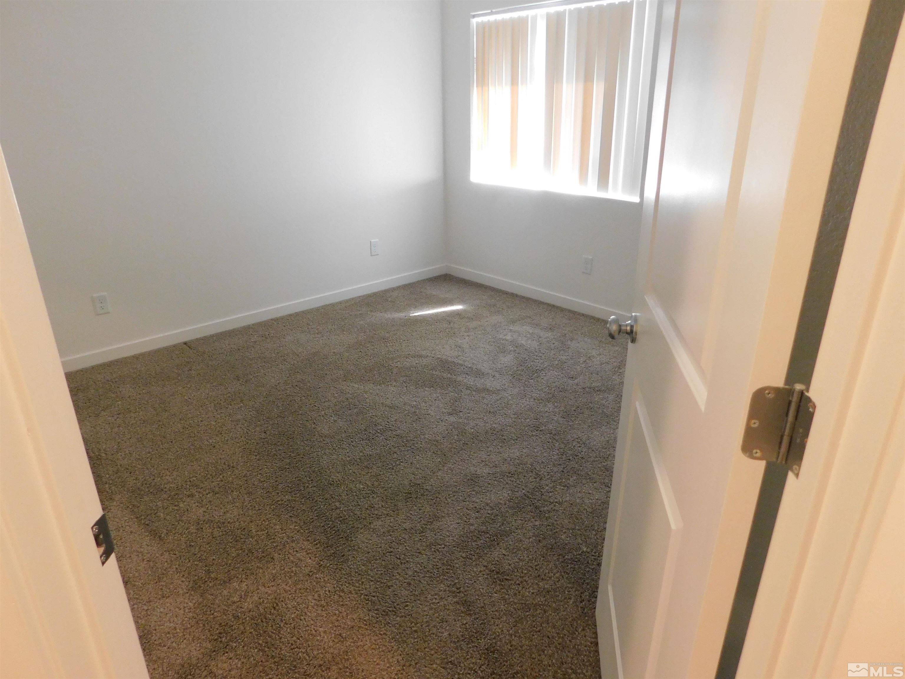 239 Misty Way Dayton, NV 89403 - Photo 10 of 29 a view of an empty room with a window
